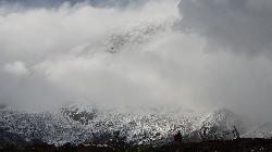 The clouds break in the late afternoon, and reveal parts of the gigantic south face of Annapurna I.