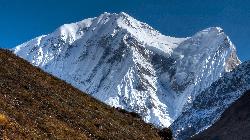 Annapurna III rising over the brown meadows of the Annapurna Sanctuary.