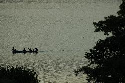 Locals on the boat visit the holy shrine in the middle of the lake.