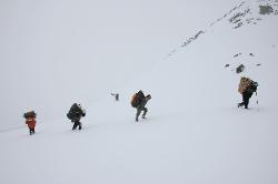 Climbing the steep, snow-bound hillside towards the pass.