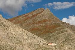 High above the valley stands  a monastery.