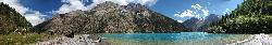 Panorama of the northern shore of Phoksumdo lake. Our horses get a short break to graze while we enjoy the Nepali staple diet of dal baht - rice with lentils. It's hard to imagine a more perfect lunchspot.