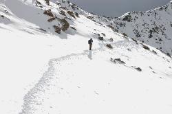 After a rough night we were lucky and not too much new snow fell, the weather has cleared a little and we can attempt our last high pass. The crew broke trail already and carried many loads because horses can't carry anything in these conditions.