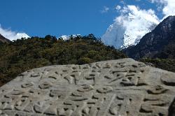 Kangtega rising over mani stone; forest reach up to almost 4'000 meters.