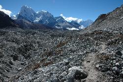 Porters crossing the big glacier in the opposite direction; Cholatese in the background.