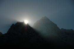 The early rays slowly climb up over the ridge.
