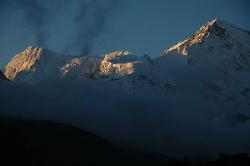 Sunset on Cho Oyo rising over the evening fog that is blown up the Gokyo valley.