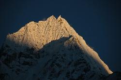 Last rays of the sun hit the flanks of Thamserku.