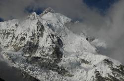 The rocky pyramid of Kangchenjunga's summit rises above the glaciers and peaks.