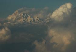 Makalu rises above the late-monsoon clouds that build over the hot plains of India.