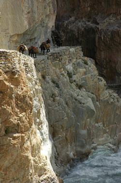 Trails are often chiselled out of steep rock faces; with the river raging straight below.