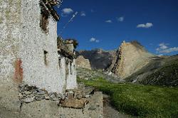 Whitewashed houses appear in the green barley fields; but the main village stands at the end of the valley.