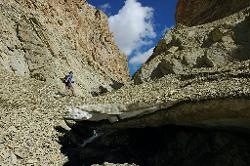 The icebridge is covered by rubble and dripping heavily in the hot sun; but probably more stable than some of the manmade bridges in the area.