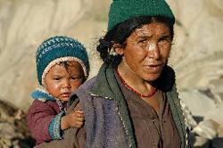 Woman with her baby in Nyerak; during most of the afternoon she worked in the pea fields with her other son.