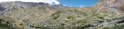 Panorama of Lingshed and its fields that are spread out in the valley and on slopes. The monastery is built on the rim and overlooks the valley.