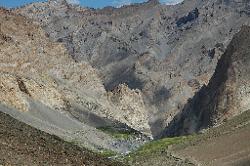 The picturesque village of Photoskar clings to a barren slope at the foot of sheer cliffs.