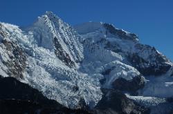 Minor peak with steep flanks and falling glaciers.