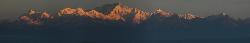 Panorama from Darjeeling;  from Jannu to Narsing the peaks glow orange from the rising sun.