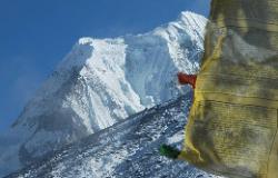 Chombo's icy flanks behind a prayerflag.