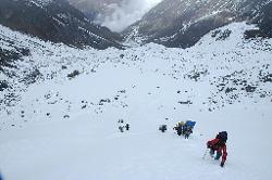 The toughest part on the way to the pass, a steep slope with snow to the waist and ugly boulder in between. If I hadn't broken trail we would have to turn around, so I go ahead and manage to motivate the porters to follow: two porters at the end were about to turn around, another one is scared and thinks he'll die. I check everybody and they are fine, no threat of injuries or frostbite but to be sure I hand out my extra clothes.