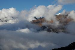 More fog starts to move in from camp, view towards north where the black triangle might be a mountain near the Lungnak La