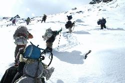 The first deep snowfield is crossed with few complaints by the porters.